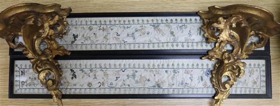 A pair of Chinese embroidered silk sleeve panels, 51.5 x 7cm., and a pair of giltwood wall brackets, 19cm
